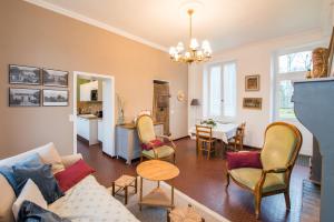 a living room with a couch and chairs and a table at Château de la Malmaison in Champillon