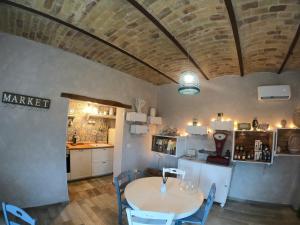 a kitchen and dining room with a table and a brick ceiling at Az. Agr. Parco dei Buoi in Larino