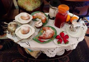 a table topped with plates of pastries and fruit at B&B Atmosfere Del Centro Storico in Naples