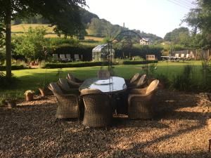 un grupo de sillas alrededor de una mesa en un patio en Forthay Bed and Breakfast en North Nibley