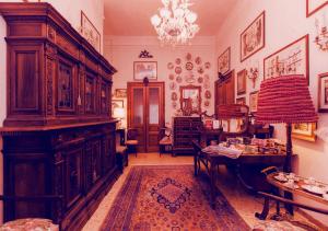 a room with a large wooden cabinet and a table at B&B Atmosfere Del Centro Storico in Naples