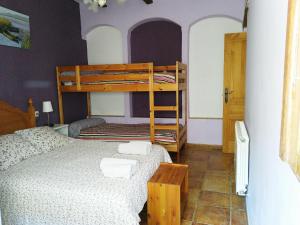 a bedroom with a bed and a bunk bed at Casa Rurales Antigua Casa del Relojero in Astudillo