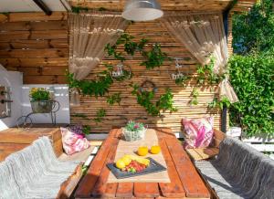 een houten tafel met fruit op een patio bij Private Villa Bella Luna by "elite" in Zakynthos
