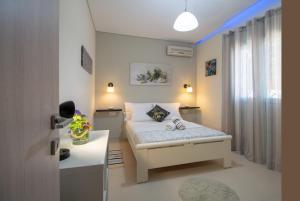 a small bedroom with a bed and a desk at Private Villa Bella Luna by "elite" in Zakynthos