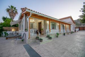 een huis met een veranda en een patio bij Private Villa Bella Luna by "elite" in Zakynthos