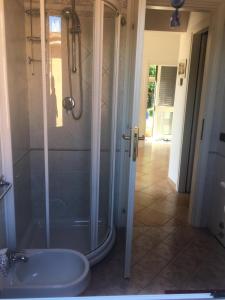 a bathroom with a shower and a sink at Panoramica del Porticciolo in Rio Marina