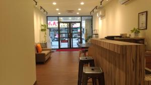 a lobby of a store with a bar and stools at 夏舞民宿 in Hualien City