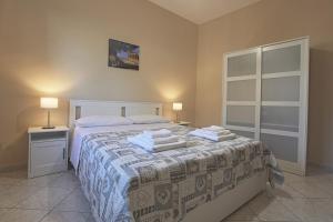 a bedroom with a bed with towels on it at Zeus Atabyrios - Locazione Turistica in Agrigento