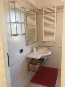 a bathroom with a sink and a mirror at Panoramica del Porticciolo in Rio Marina