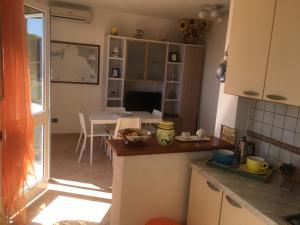 a kitchen with a table and a dining room at Panoramica del Porticciolo in Rio Marina