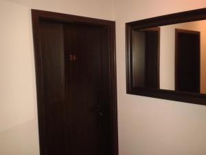 una puerta marrón y un espejo en una habitación en Pension Levi, en Berlín