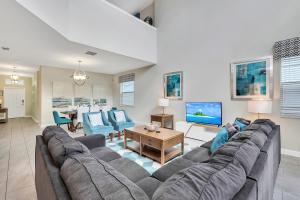 a living room with a large couch and a table at Stylish Home wPrivate Pool&Spa, near Disney in Davenport