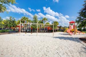 a playground with a slide in the sand at 5532 Misty Oak Circle in Davenport