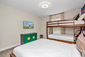 a bedroom with two bunk beds and a window at Private Pool Themed Bedrooms FREE Waterpark in Kissimmee +57 photos
