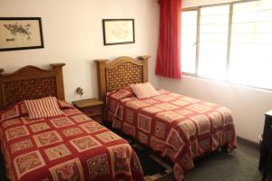 En eller flere senge i et værelse på Hostal La Encantada
