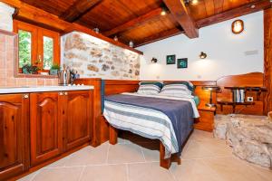 a bedroom with a bed in a room with wooden walls at Casa Campanella Holiday House in Rovinj