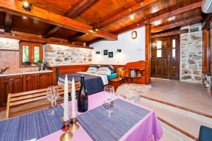 a room with a bed and a table with wine glasses at Casa Campanella Holiday House in Rovinj