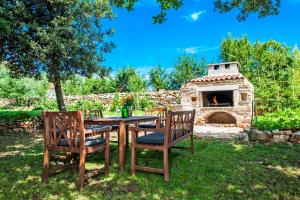 a table and chairs and a stone pizza oven at Casa Campanella Holiday House in Rovinj