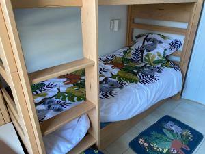 two bunk beds in a room with a bed at Le petit paradis de Valentin in Argelès-sur-Mer