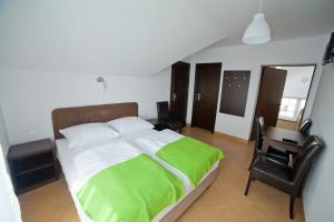 a bedroom with a bed and a desk and a chair at Willa KAMA in Karwia
