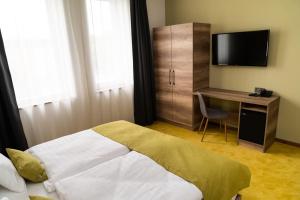 Postel nebo postele na pokoji v ubytování Hotel Kristály Konferencia & Wellness