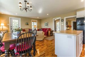 a kitchen and living room with a table and chairs at Lovely Lac-Brome 3 Bedroom Lakefront Cottage in Lac-Brome