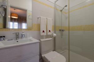 a bathroom with a toilet and a sink and a shower at Casa da Praia in Zambujeira do Mar