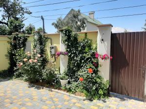 a house with flowers on the side of it at Гостевой дом in Chornomorsk