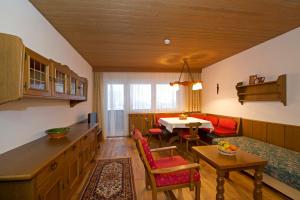 a kitchen and living room with a table and a couch at Tirolerhaus in Walchsee
