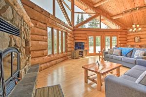 a living room with a fireplace in a log cabin at Lakefront Log Cabin with Dock about 9 Mi to Lutsen Mtn in Lutsen