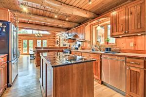 a kitchen with wooden cabinets and a large center island at Lakefront Log Cabin with Dock about 9 Mi to Lutsen Mtn in Lutsen