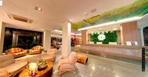 a lobby with couches and chairs in a building at Amazon Plaza Hotel in Cuiabá
