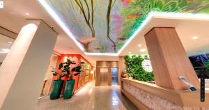 a hallway with a fish painting on the ceiling at Amazon Plaza Hotel in Cuiabá