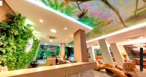 a lobby with a large wall of plants at Amazon Plaza Hotel in Cuiabá
