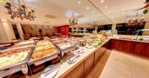 a buffet line with many different types of food at Amazon Plaza Hotel in Cuiabá