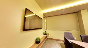 a conference room with a projection screen and a table and chairs at Amazon Plaza Hotel in Cuiabá