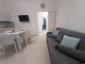 un soggiorno con un divano e un tavolo di GIOANTHONY a Porto Cesareo