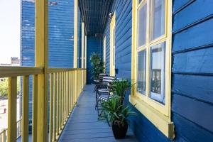 a porch of a blue house with chairs and windows at Manoir des Remparts- Renovated 3 Bedroom Oasis in Quebec City