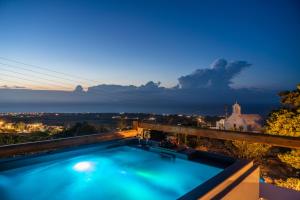 a swimming pool on top of a building at Noelia Suites in Oia