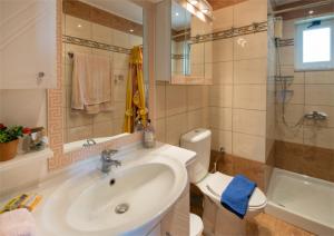 a bathroom with a sink and a toilet and a tub at Villa sotiris in Kissamos