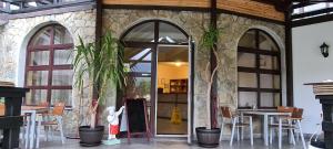 a restaurant with tables and chairs and a glass door at Poiana Rasnoavei in Râşnov