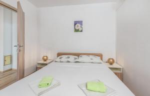 a bedroom with a bed with two towels on it at Apartments Mioković in Soline