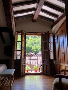 Habitación con puerta que da a un balcón. en Posada La Cuadrona en La Hermida