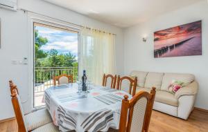 a dining room with a table and a couch at Apartments Mioković in Soline