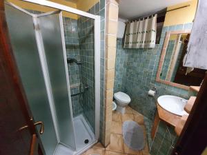 a bathroom with a shower and a toilet and a sink at Casa Sole in Villasimius +38 photos