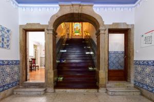 a staircase leading up to a building with blue and white tiles at Casa de Sao Mamede Hotel in Lisbon