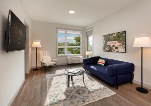 a living room with a blue couch and a table at The Shore in Kelowna