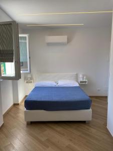 a bedroom with a bed with a blue comforter at Affittacamere Benedetta e Isabelle in Vernazza