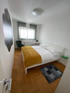 a bedroom with a bed and a chair in it at Bizi Green - Zagreb South in Zagreb