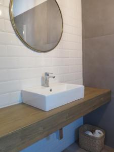 a bathroom with a white sink and a mirror at LA CASINA DEL OLIVO in Ribadesella +36 photos